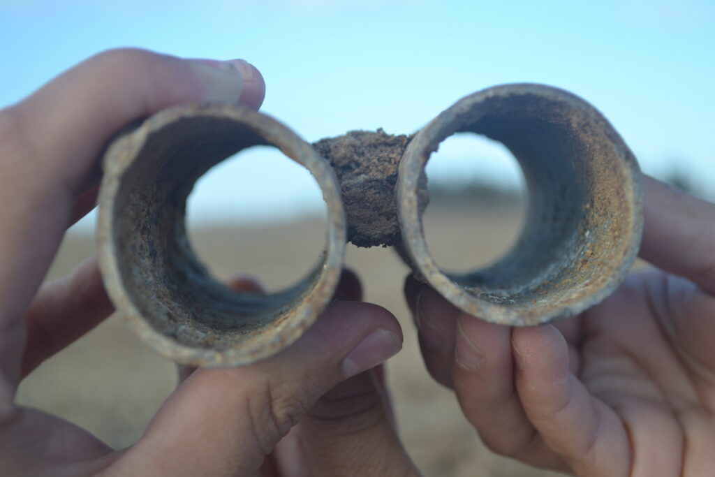 Two hands holding an object fashioned into binoculars.